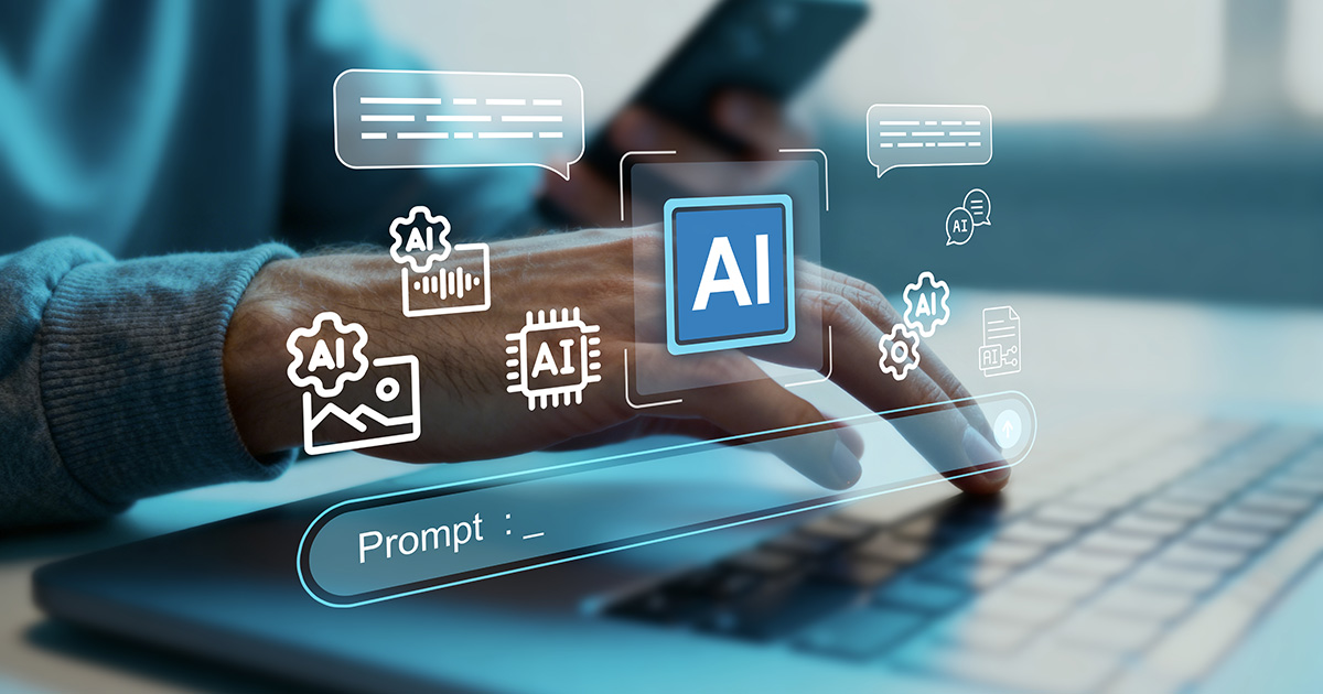 Person typing on a laptop with holographic AI icons floating above representing artificial intelligence tools and interaction