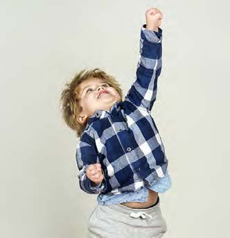 A small boy jumping into the air